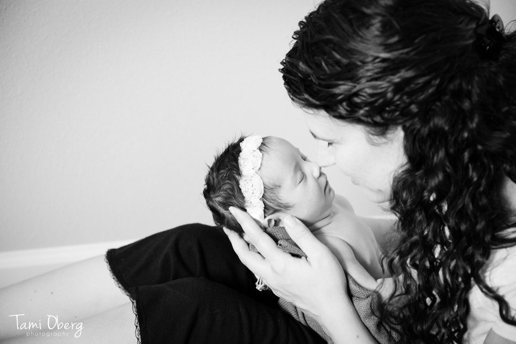 mom and dark haired newborn baby girl