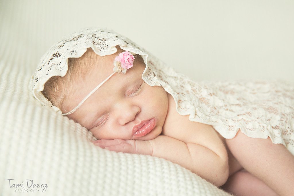 baby with flower headband and lace