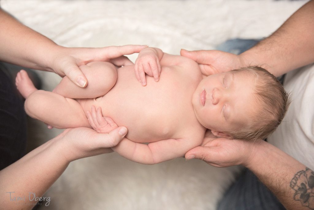 parents holding newborn in their hands