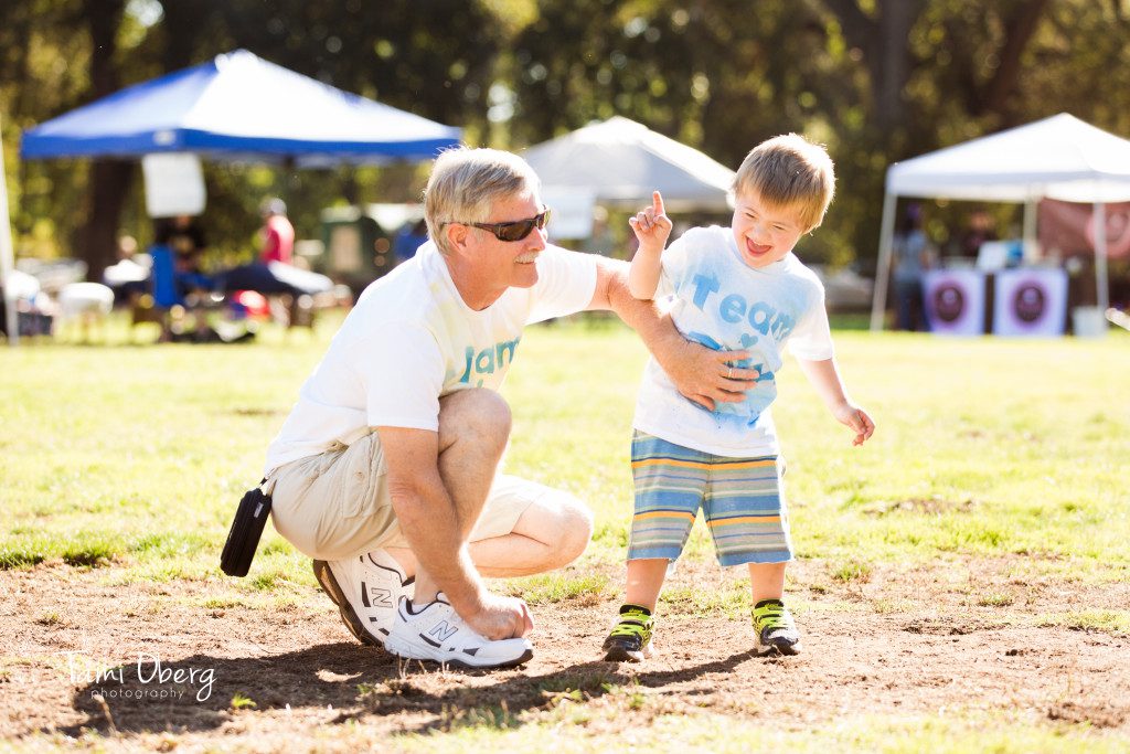 grandfather tickling his grandson