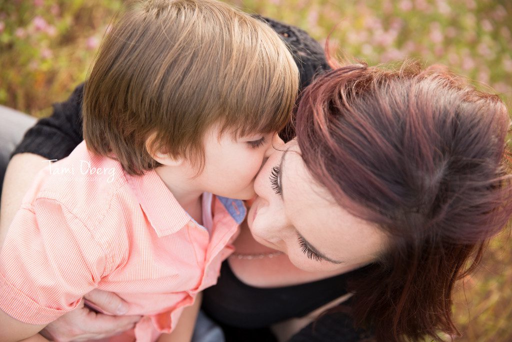 little boy kissing his mom on the cheek