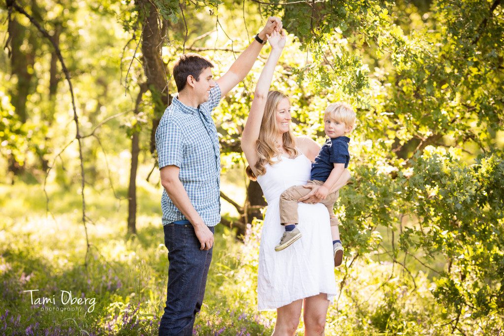 maternity family dancing in a field