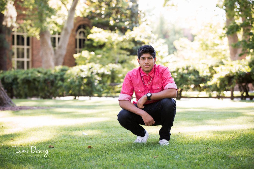 senior posing in grass