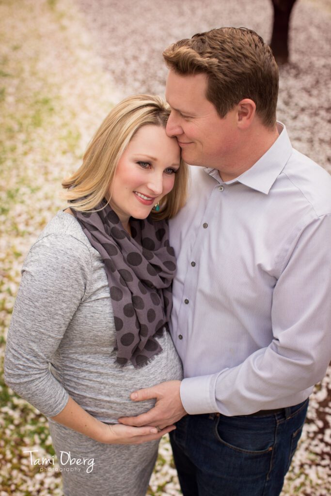 expecting father kissing mother on forehead