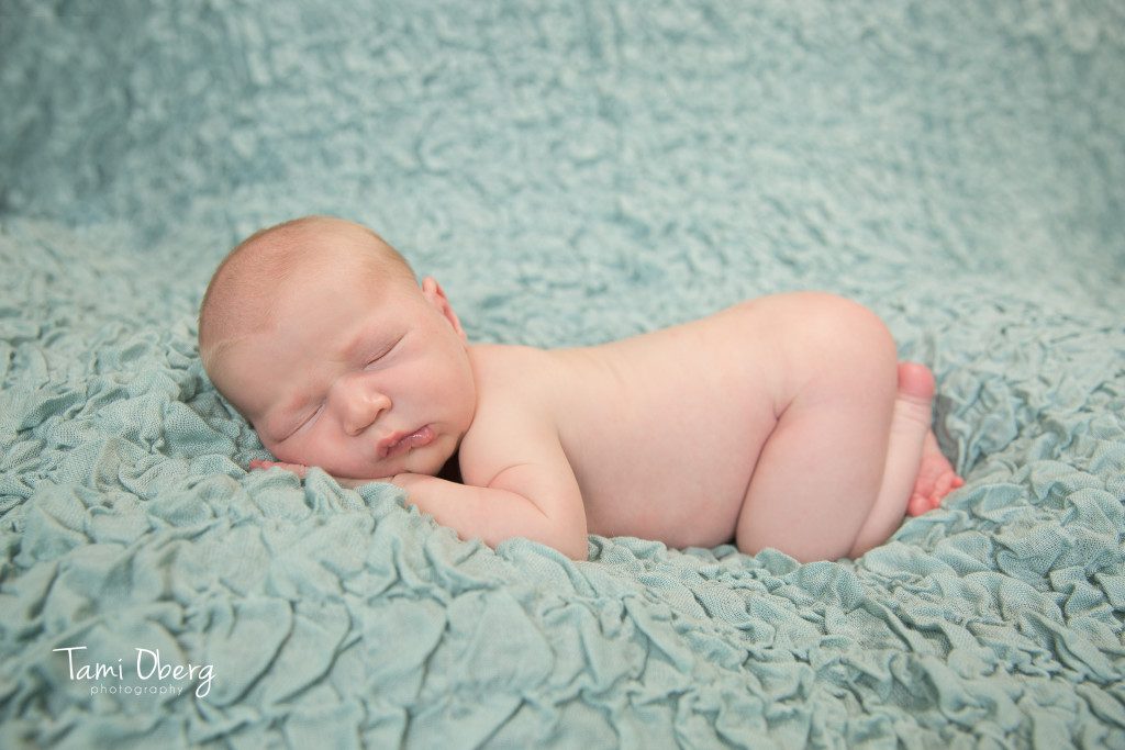 naked newborn baby in tushy pose