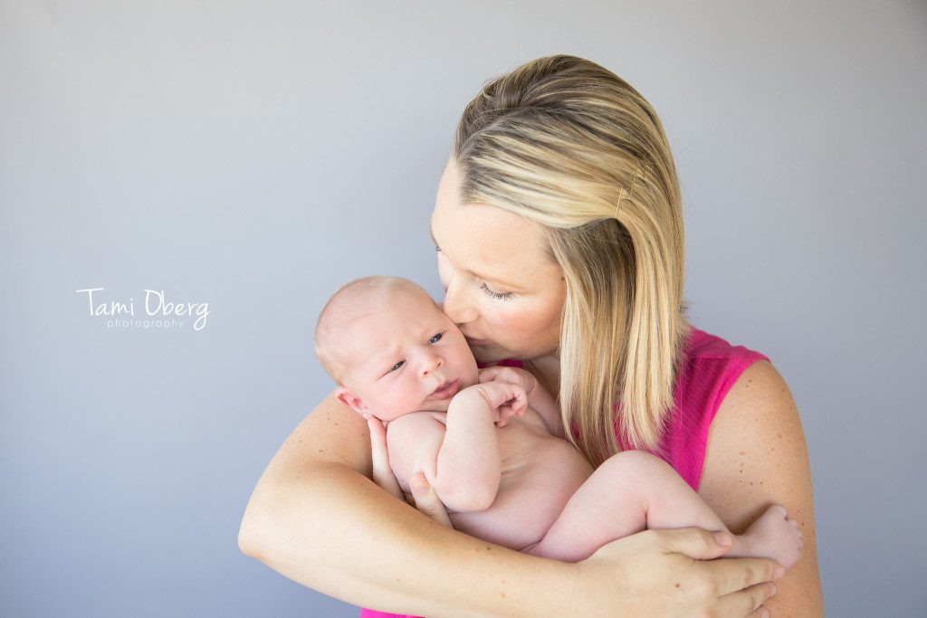 mom kissing her baby