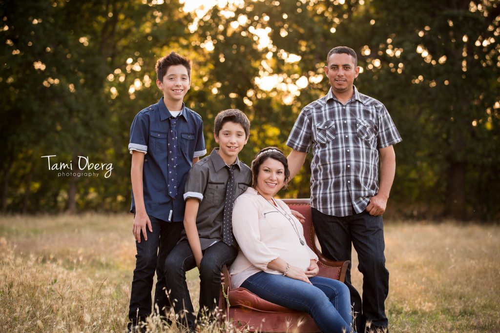 maternity family on pink chair