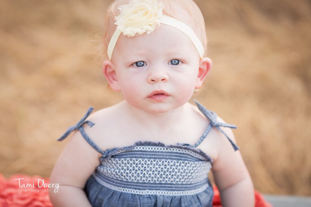close up of a little blue eyed girl with a headband