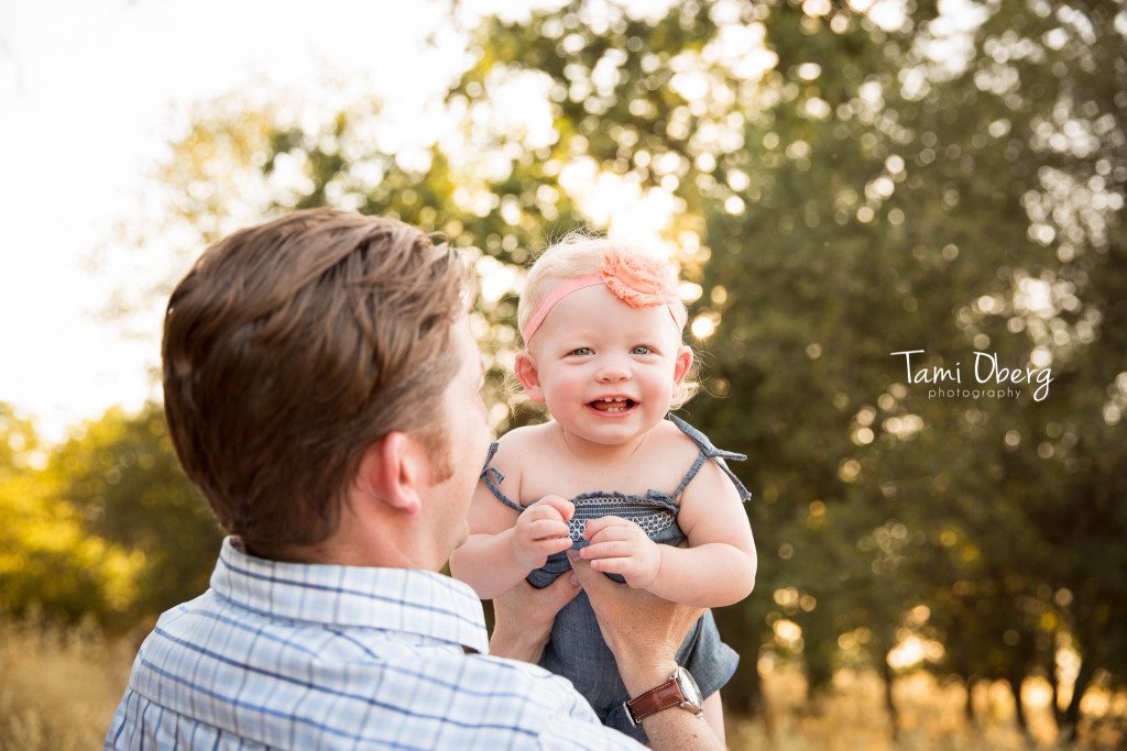 dad throwing toddler in the air