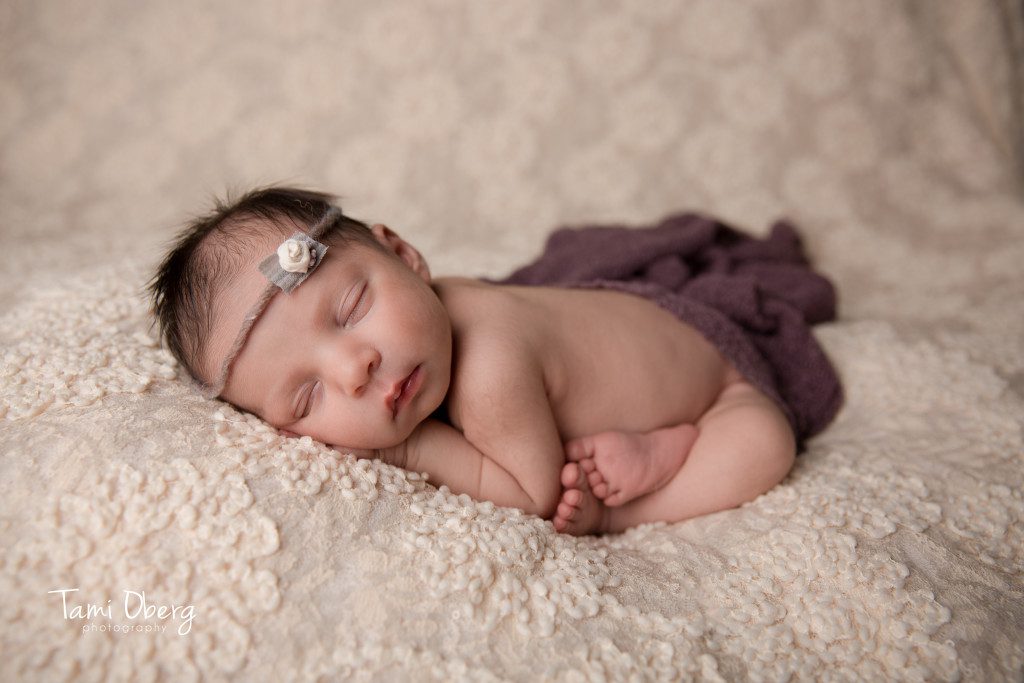 baby girl lying on lace pull back