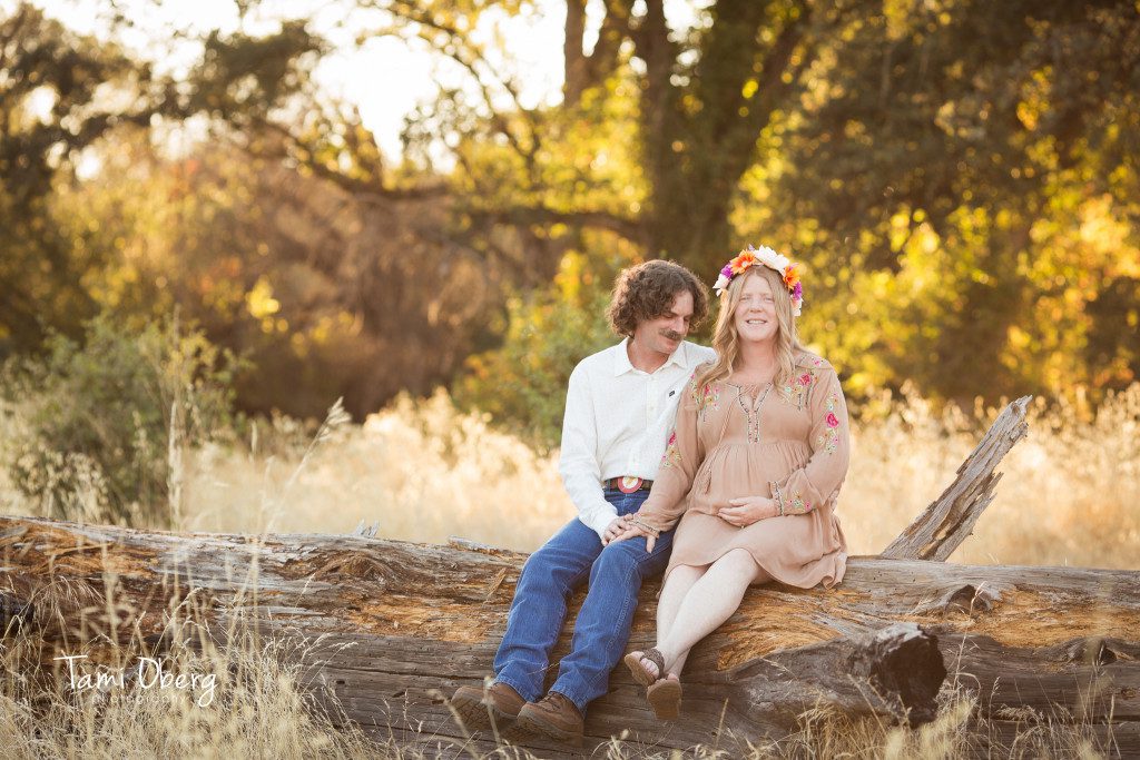 maternity couple on a log