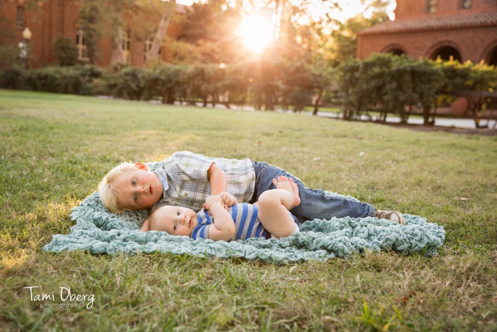two brothers lying on a blanket