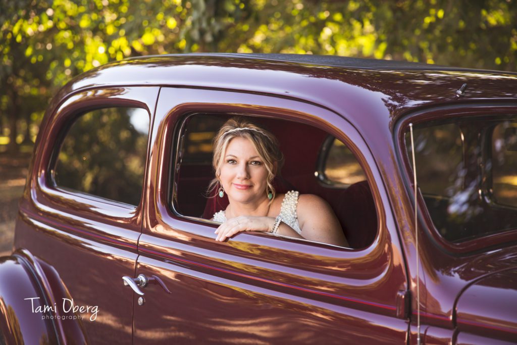 bride in a maroon classic car
