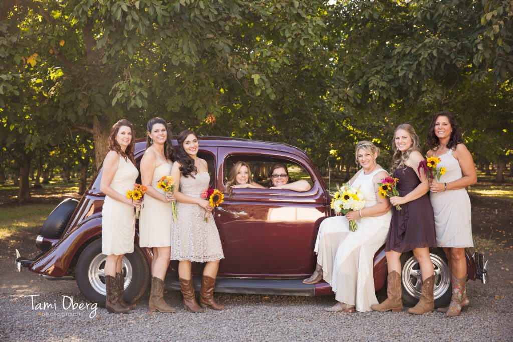 bride with bridal party on a classic car
