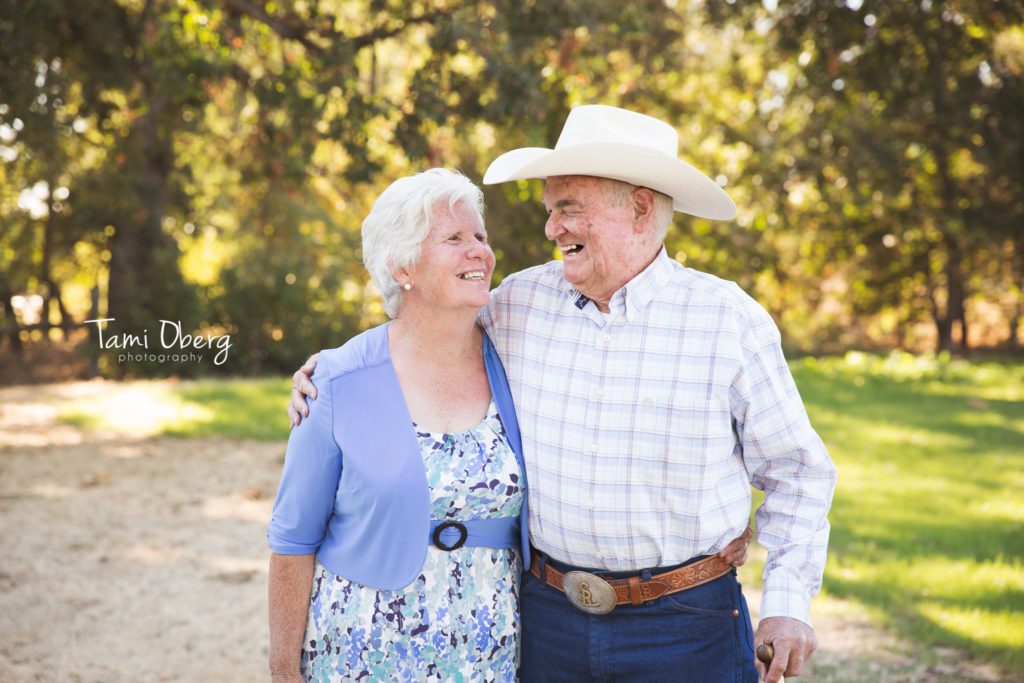 groom's parents looking and smiling at each other