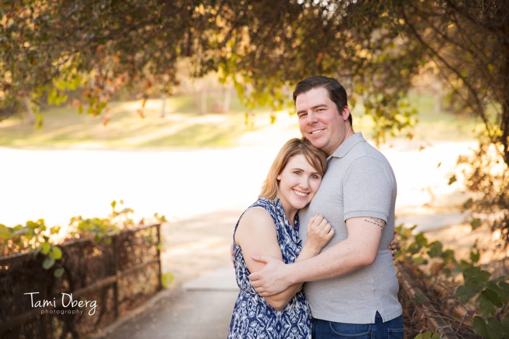 couple posing on bridge