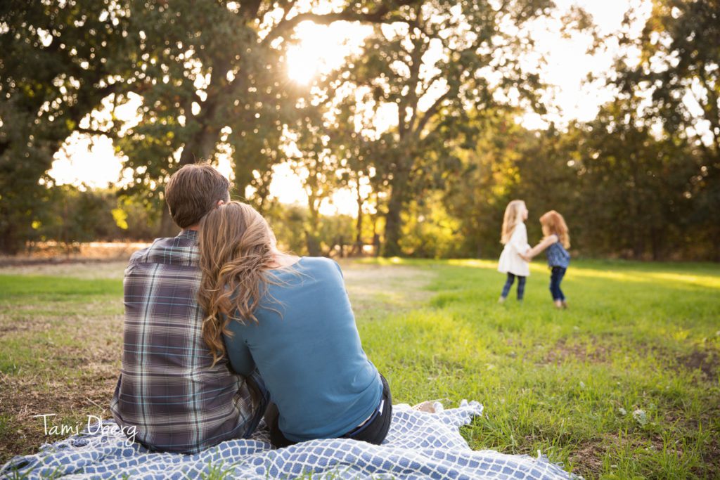 couple watching children play in the distance