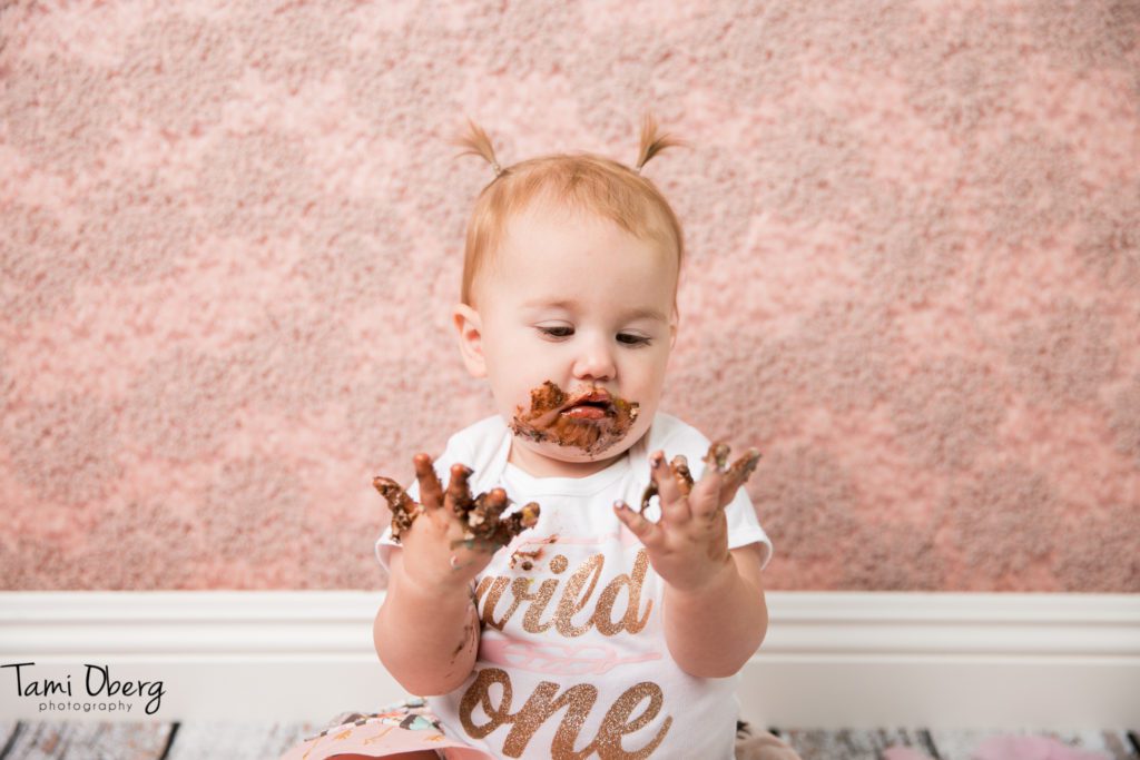 baby looking at dirty hands