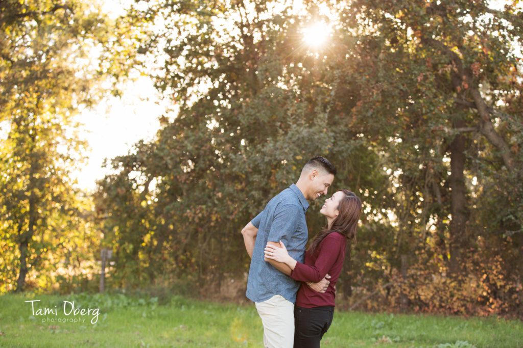 couple looking at each other with sunburst in the background