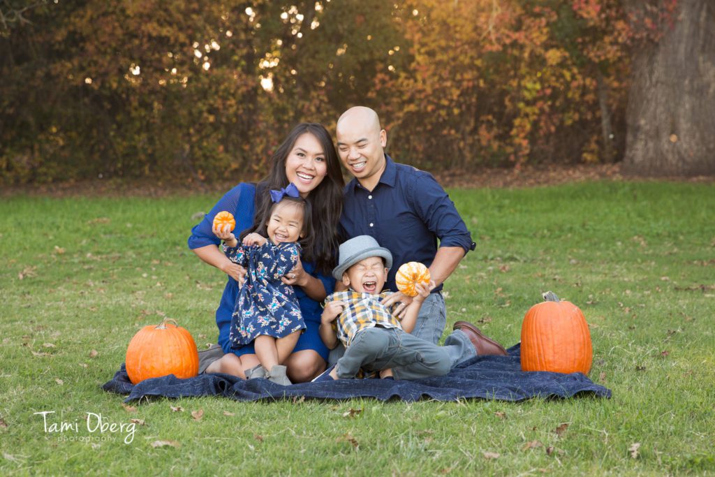 laughing family with pumpkins