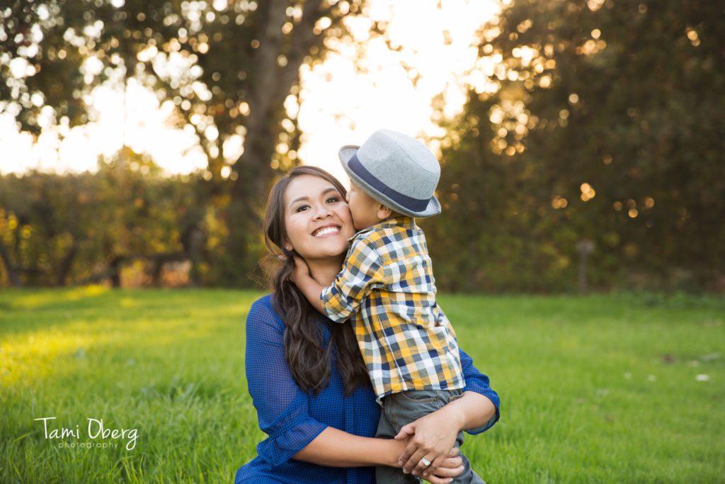 little boy kissing his mom on the cheek