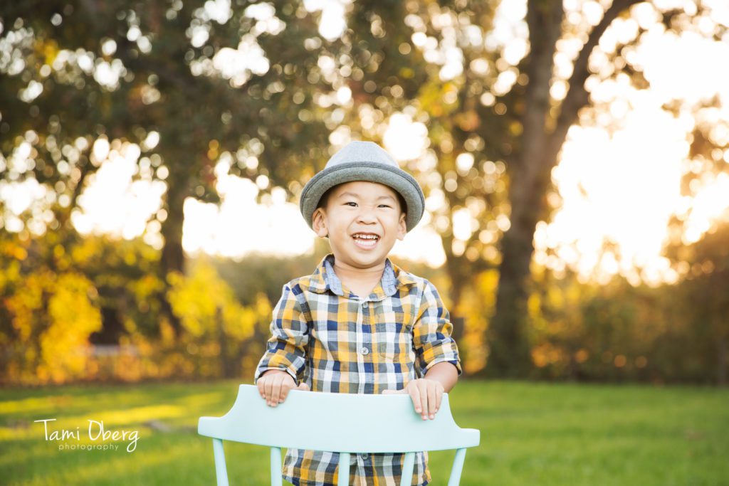 little boy smiling in an aqua chair
