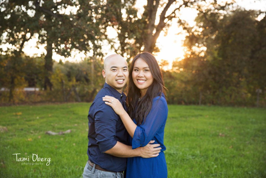 mom and dad smiling in magic hour light