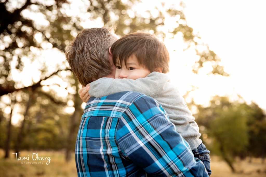 little boy hugging his dad