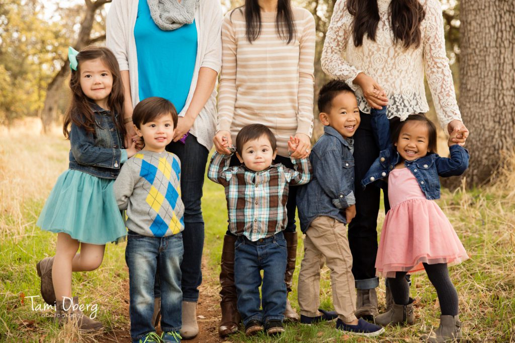 five children standing in front of their moms